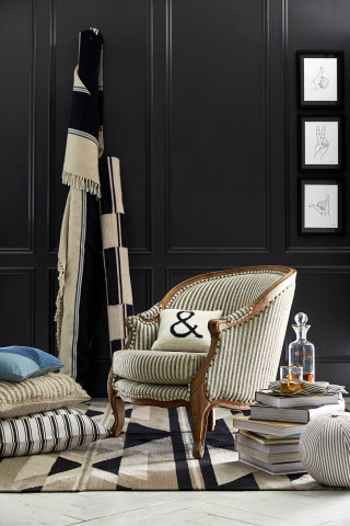 The Current Elliott Bergere Chair & Pillows from Pottery Barn.
