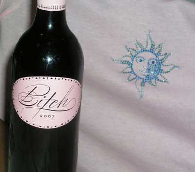 The "intriguing" B*tch wine packaging photographed next to Travertine's custom Pink Swarovski Resort T